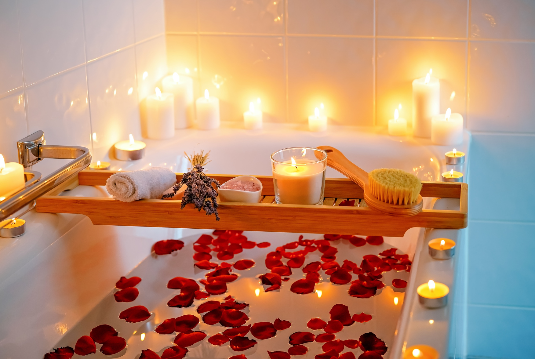 Spiritual aura cleansing flower bath for full moon ritual with candles, aroma salt, lavender and rose petals.